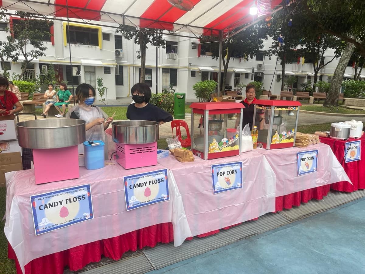 Staffed candy floss cart at an HDB carnival
