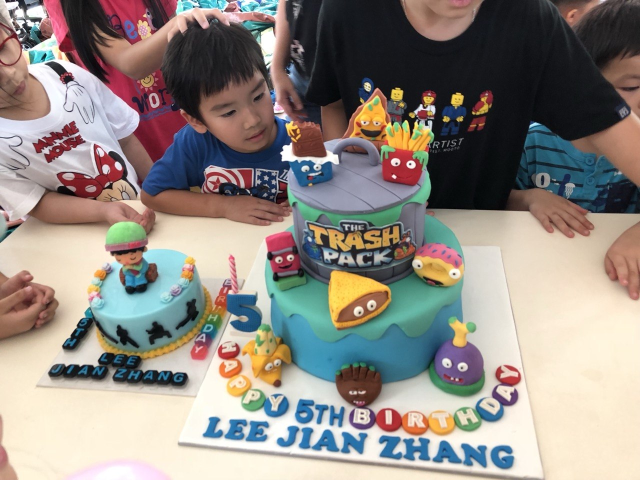 Kids around a birthday cake table
